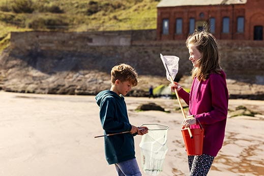 Children on the beach with fishing nets
