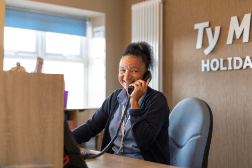 Lady working at reception at a Parkdean Resorts Holiday Park