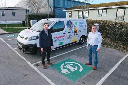 Two men stood next to a van