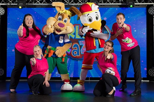 Characters dancing and entertaining children at a holiday park 