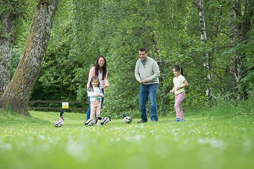 Family playing together in a field