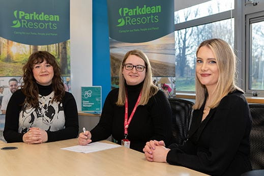 Three corporate women signing an agreement