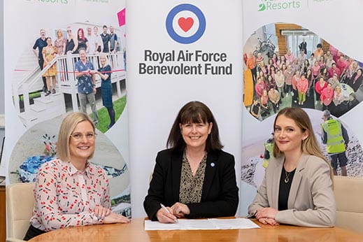 Three corporate women signing an agreement