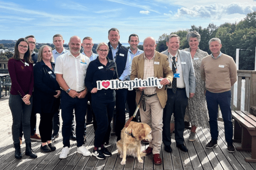Group of people with a hospitality sign