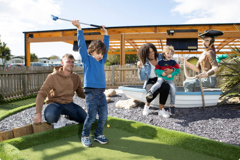 Family playing mini golf at Parkdean Resorts