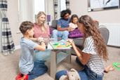 Family doing arts and crafts in caravan at Parkdean Resorts