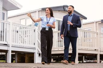 Man and woman walking through caravan park