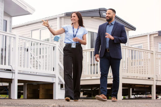 Man and woman walking through caravan park