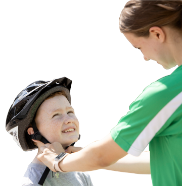 Mother putting a cycling helmet on her child