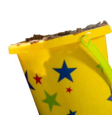 Yellow bucket filled with sand with blue green and red stars on the front