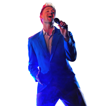 Man wearing full blue suit singing into a microphone