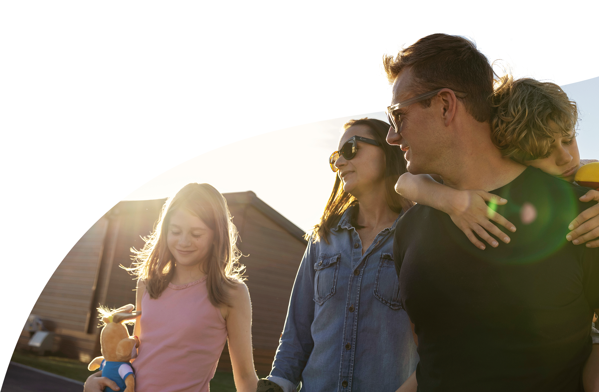 Family walking in the sunshine wearing sunglasses