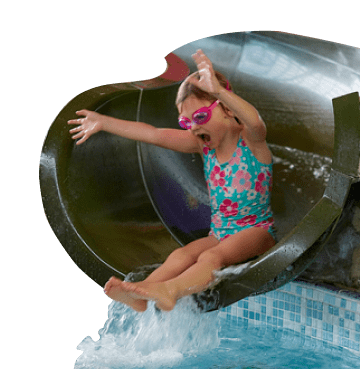 Little girl at the end of a water slide wearing blue swimming costume and pink goggles