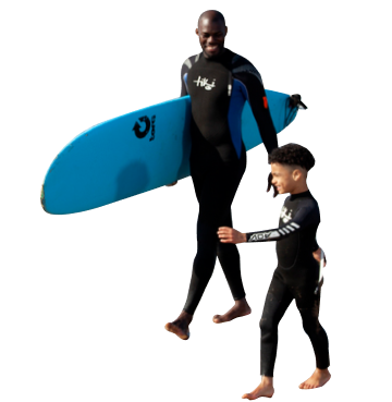 Dad and son walking along a beach holding a blue surfboard