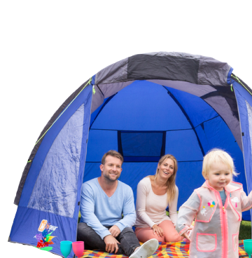 Man and woman sat inside a blue tent with young child running out