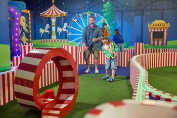 Kids playing mini golf