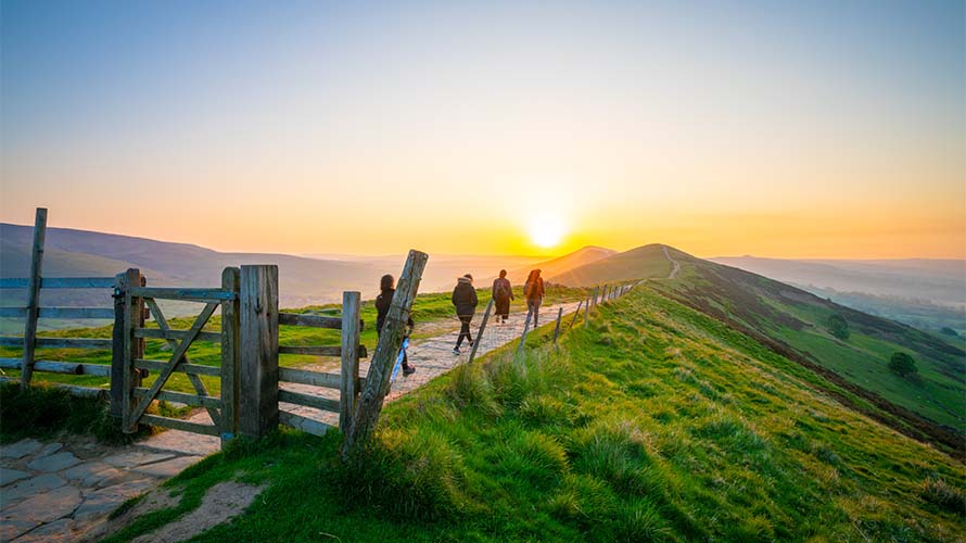 Hikers walking along a trail in the English hillside
