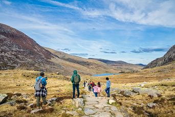 A family walking through Snowdonia National Park in Wales