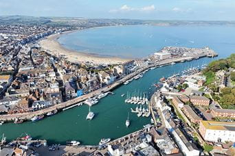 An aerial view over Weymouth harbour and beach