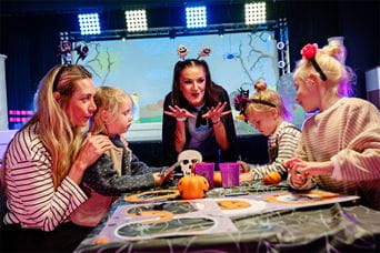 A family taking part in a Halloween activity at Parkdean Resorts