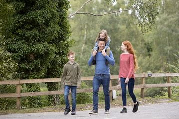 A family walking along a path at Warmwell Holiday Park in Dorset