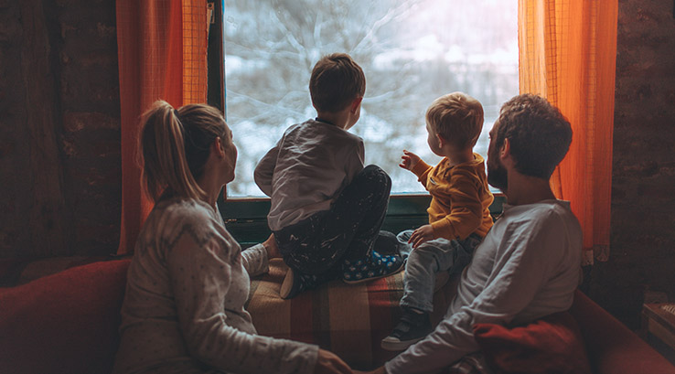 Family enjoying a cosy lodge holiday at Christmas time