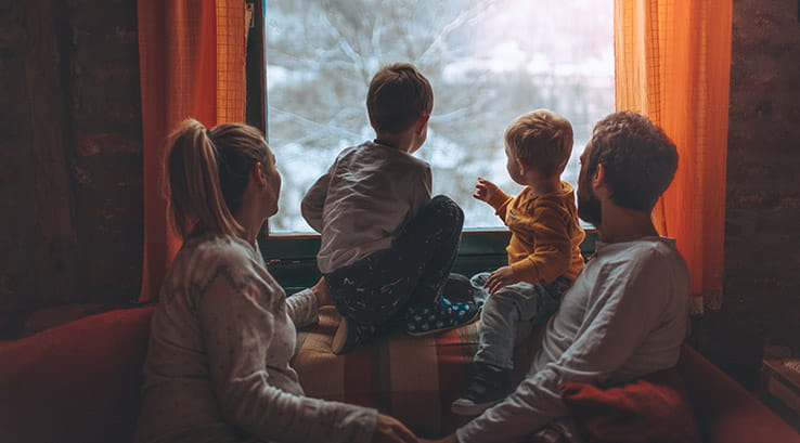 Family enjoying a cosy lodge holiday at Christmas time