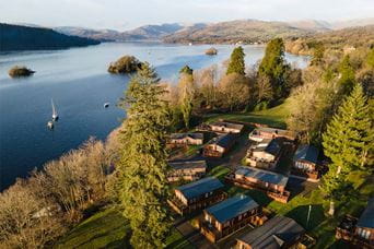 An aerial view of luxury holiday lodges in a holiday park on the shore of Lake Windermere