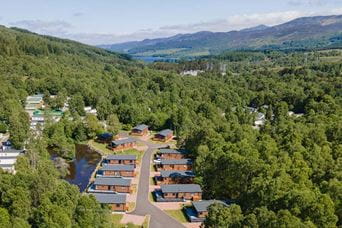 An aerial view of lodges in the forest at Tummel Valley Holiday Park