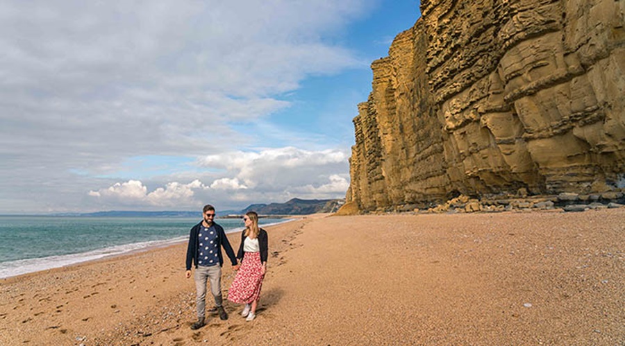 Couple walking along a British Beach
