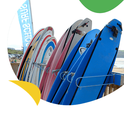 Surfboards stacked up for hire
