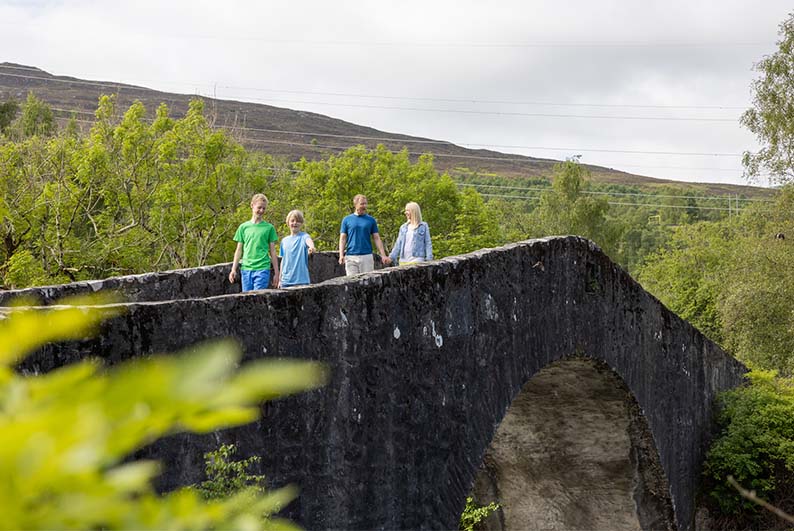 A family walking through the Scottish Highlands