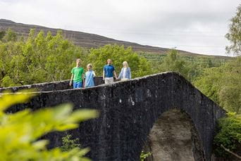 A family walking through the Scottish Highlands