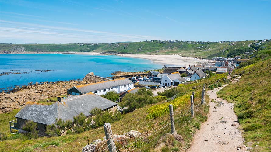 A view of a coastal path in Cornwall leading down to a beach