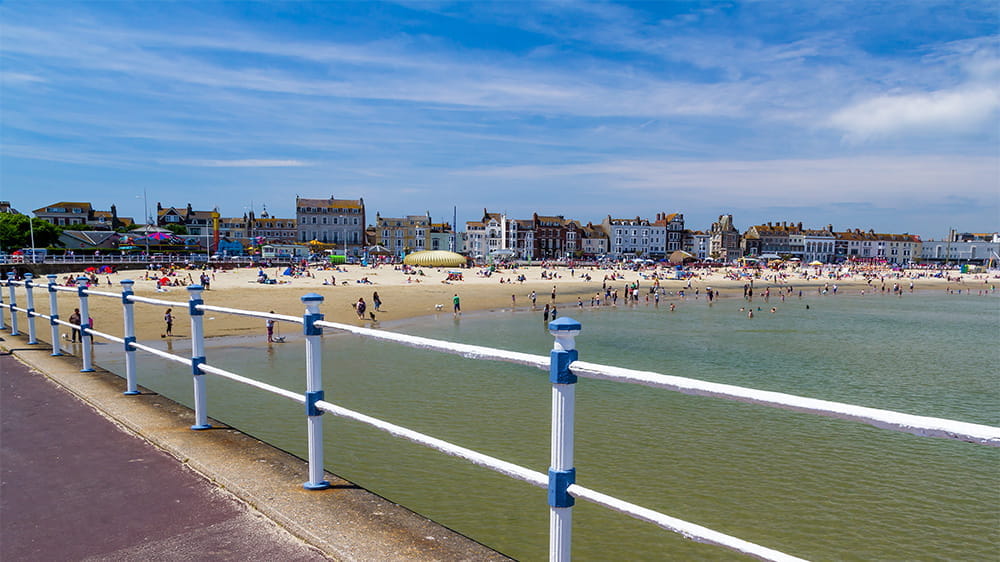 A view over bustling Weymouth Beach from the pier