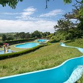 The outdoor swimming pools and slide at Newquay Holiday Park in Cornwall