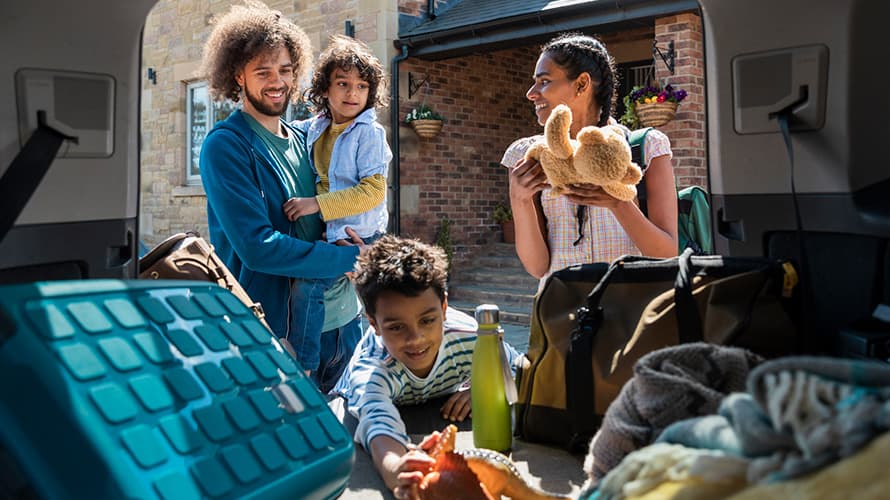 A family packing the car for an affordable UK holiday