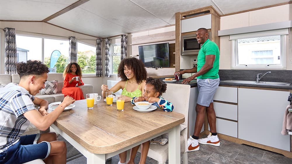 A family making breakfast in a caravan