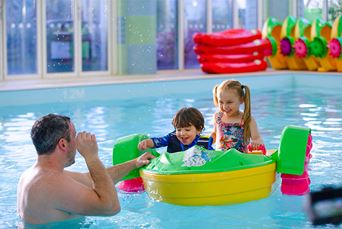 Kids on the aqua paddlers in the indoor swimming pool