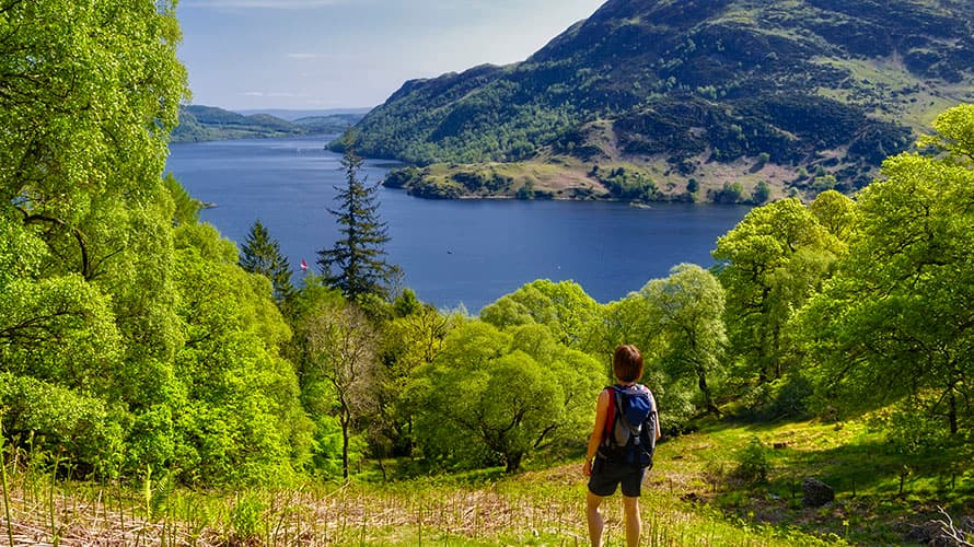 Walker enjoying the view over a lake in the Lake District