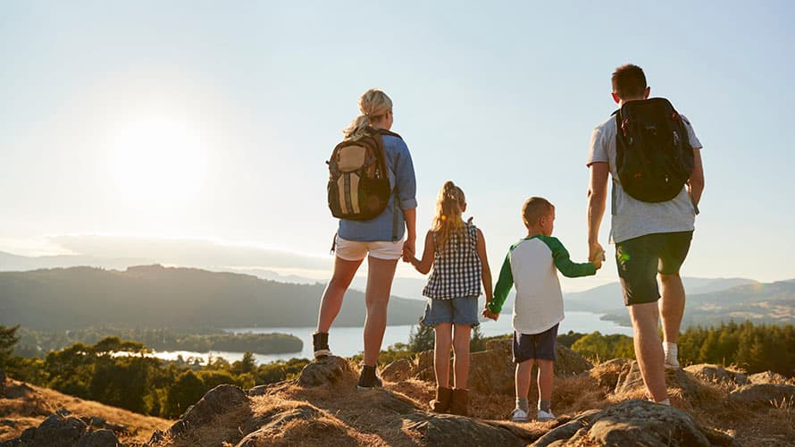 A family at the peak of a hill in the Lake District