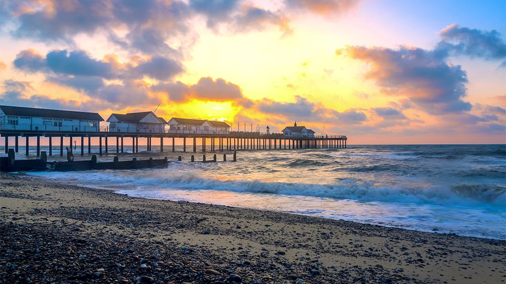 A pier stretching out to sea at Sunrise in Southwold