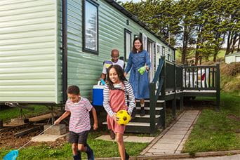 A family stepping out of their caravan on holiday