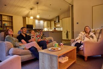 A family enjoying a relaxing night in, in their holiday lodge
