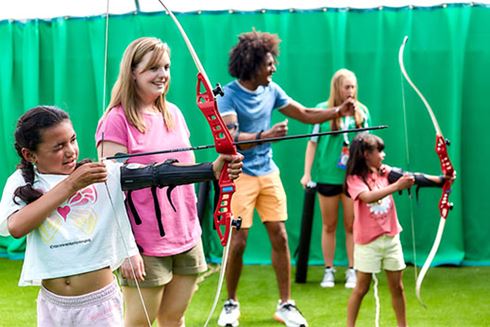 A family taking part in an archery lesson at Parkdean Resorts