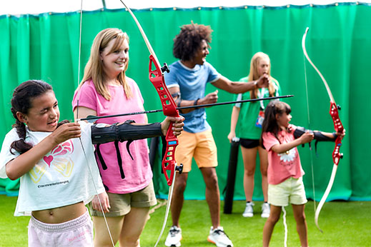 A family taking part in an archery lesson at Parkdean Resorts