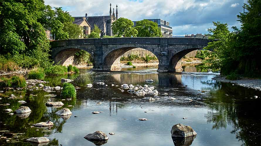 A stone bridge crossing a river in Kendal in Cumbria