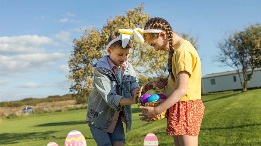 Brother and sister doing an Easter egg hunt on a caravan park