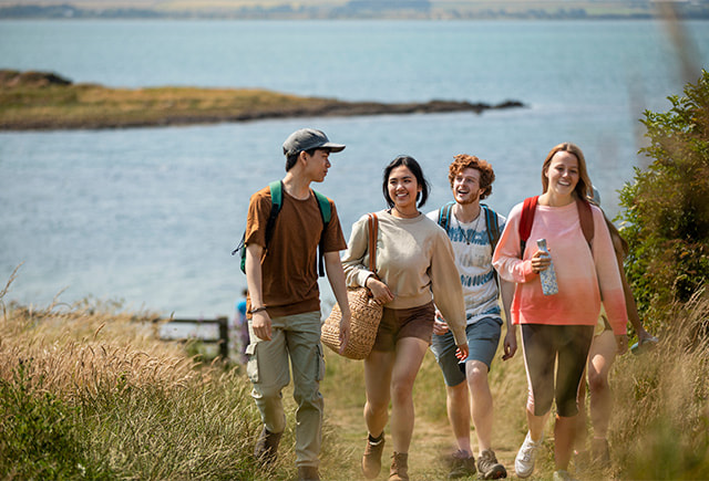 A group of friends going for a walk at the coast