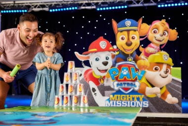 Dad and daughter smiling with PAW Patrol characters